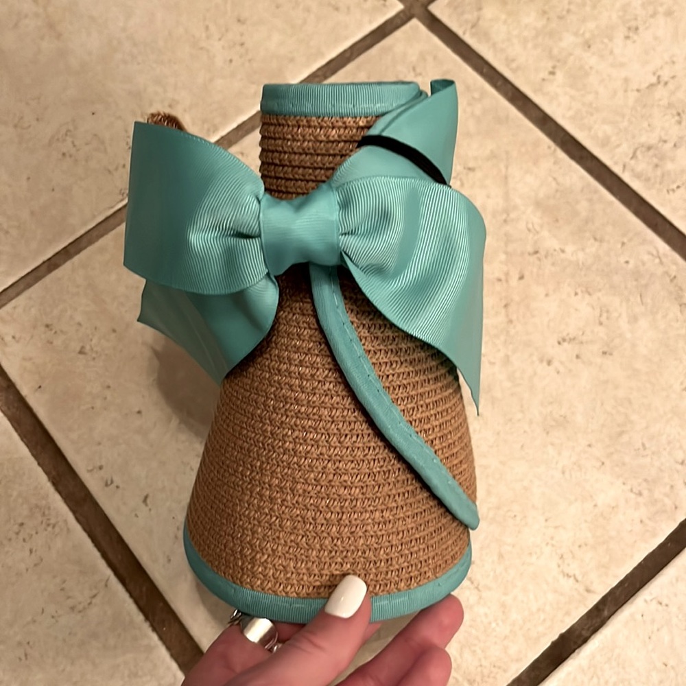 Straw sun visor with teal ribbon brim and bow.